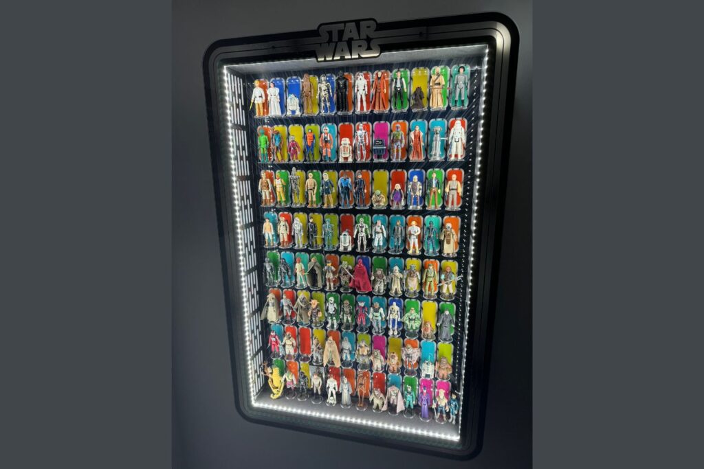Vintage Kenner Star Wars figures collection in a display case